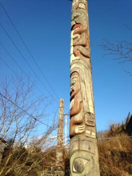 totem pole against blue sky.