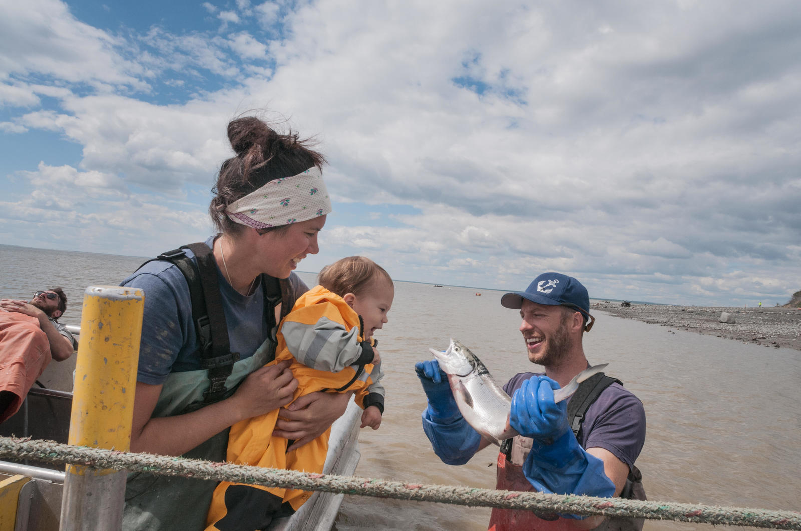 Fishing family-Mom, daughter and Dad hold sockeye salmon.  Graveyard Point, Bristol Bay, Alaska